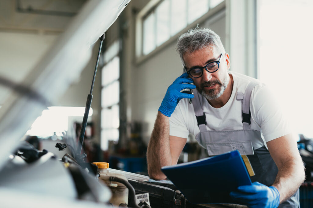 mechanic ordering car parts in car service